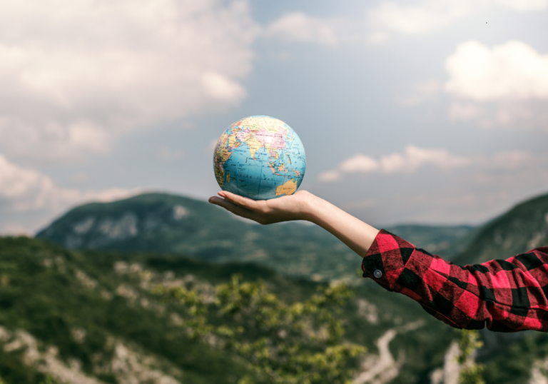 A lady holding a terrestrial globe
