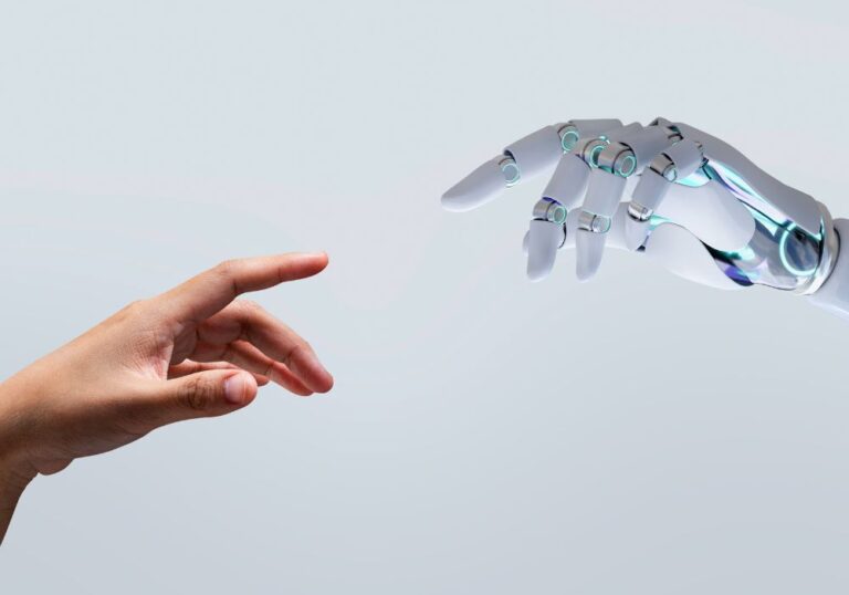 Hands of a humanoid robot and of a human trying to touch each other