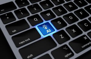 Computer keyboard with blue light on that spells AI